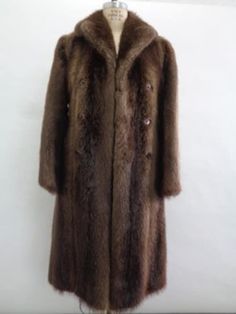 DESCRIPTION: BEAUTIFUL & VERY STYLISH NATURAL BROWN LONG HAIRED BEAVER FUR COAT FOR MEN MADE FROM FULL SKINS, USING "LET OUT" TECHNIQUE, THE BEST! THE SLEEVES ARE STRAIGHT, THE COLLAR TYPE IS "NOTCH", IT CLOSES WITH FRONT BUTTONS AND HAS TWO SIDE POCKETS. THIS COAT IS SHOWROOM NEW ITEM! AFTER BUYING THIS ITEM, IT WOULD BE VERY MUCH APPRECIATED IF YOU COULD PROVIDE YOUR HEIGHT, WEIGHT AND BUST CIRCUMFERENCE, SO WE CAN ADJUST THE COAT TO YOUR SIZE, BEFORE SHIPPING, IF NEEDED. IT WILL ALSO HELP US TO SHIP YOUR ITEM SOONER, THANK YOU! :) MEASUREMENTS:   SIZE: 36 XSMALL LENGTH: 46"  SLEEVES: 32" LONG LENGTH; MEASURED FROM THE SIDE OF THE NECK TO 2" BELOW YOUR WRIST, WITH YOUR ARM SIDE TO YOUR BODY WHY YOU SHOULD BUY YOUR PRE-OWNED FURS ONLY FROM OUR COMPANY? BECAUSE WE SIZE AND REPAIR OUR COATS Classic Brown Fur Coat For Work, Classic Long Fur Coat For Formal Occasions, Formal Long Brown Outerwear, Classic Brown Long Fur Coat, Classic Long Brown Fur Coat, Classic Mink-colored Formal Outerwear, Classic Mink Color Formal Outerwear, Classic Formal Fur Coat For Fall, Brown Winter Fur Coat For Formal Occasions