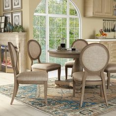 a dining room table and chairs in front of a large window with an arched doorway