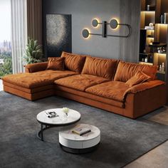 a living room with a sectional couch and coffee table in front of a large window