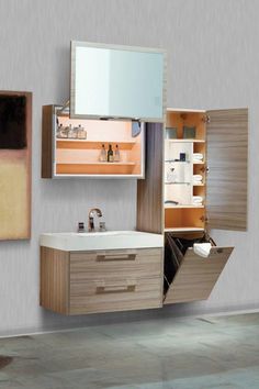 a bathroom with a sink, mirror and cabinets on the wall next to each other