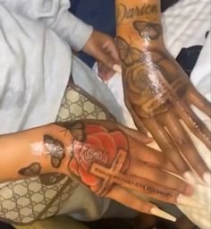 two people with tattoos on their hands