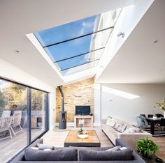 a living room with a skylight and couches