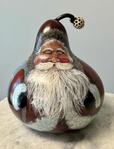 a ceramic figurine with a long white beard and mustache on it's head