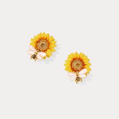 Inspired by the beauty of nature, these Sunflower & Bee Stud Earrings offer a perfect blend of elegance and cottagecore charm. Crafted with brass enamel, they make a stunning statement piece that speaks to the free spirit inside us all. Treat yourself to their luxe, yet rustic aesthetic. Sunflower & Bee Stud Earrings from Selenichast online store is fine earrings boast a delicate sunflower design and a playful bee accent for a unique and elegant look.   DETAILS Plating: 18K Gold Materials: 18K G Cat Pendant Necklace, Bee Studs, Unique Gift Wrapping, 18k Gold Earrings, Horses Pendant, Bee Earrings, Cat Pendants, Sunflower Design, Enamel Flower