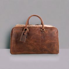 "Christmas Day Special offer Flat 70% Off With Free Shipping  ✍✍Free Personalization  Free Gift Wrapping Free Shipping ◼ Premium Full Grain Cowhide Leather: Handcrafted using the finest full grain cowhide leather, this duffel bag exudes luxury and durability, making it the perfect companion for your travels. ◼ Spacious and Versatile: With its generous capacity, this leather duffel bag offers ample space for all your essentials. Whether you're heading for a weekend getaway or a business trip, it' Rectangular Brown Travel Bag For Daily Use, Classic Bags With Top Carry Handle For Trip, Classic Travel Bag With Top Carry Handle For Trip, Classic Travel Bag With Top Carry Handle, Rectangular Leather Weekender Bag For Travel, Vintage Rectangular Travel Bag For Everyday, Classic Large Capacity Duffle Bag For Daily Use, Vintage Rectangular Everyday Travel Bag, Brown Rectangular Duffle Bag For Daily Use