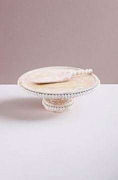 a white cake plate sitting on top of a table