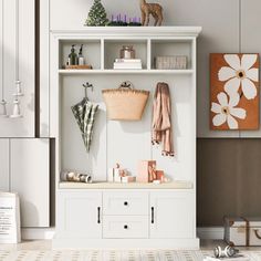 a white shelf with towels and other items on it in a room that has an animal figurine