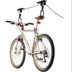 a bicycle is attached to the back of it's frame and has two wheels