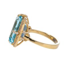 Goshwara 'Gossip' Emerald-Cut Blue Topaz Ring with Diamonds in 18K Yellow Gold Blue Topaz Total Weight: 9.72 ct Diamond Total Weight: 0.28 ct Color: G-H Clarity: VS Ring Size: 6.75 Circle Monogram, 18k Gold Ring, Blue Topaz Ring, Topaz Ring, Hand Engraving, Emerald Cut, Blue Topaz, Gold Ring, Topaz