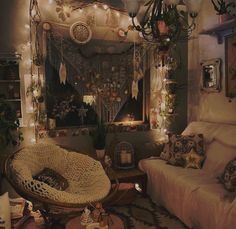 a living room filled with furniture and lots of lights hanging from the ceiling above it