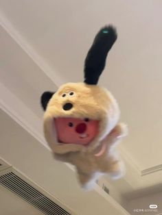 a stuffed animal is hanging upside down in the air