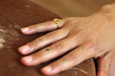 "This listing is for a lovely  14K / 18K solid gold signet ring, with an ethnic flower impressed on the top of it. In the middle of this flower a natural Ruby is setting. Granulated gold flakes are encircling the flower. This signet ring is perfect as pinkie ring. It flatters the hand in a unique, dainty way that is absolutely impossible to miss. It was designed with inspiration of Tezhip art: a Turkish art of decoration of books by using gold. The motifs are often floral and generally botanical. This ring is super unique and you cannot find this design anywhere else but in my shop. It is available in yellow gold, white gold, rose gold and sterling silver. This solid gold ring is super comfortable. It has no itchy or sharp tips, the feeling on the hand is natural and you will get used to i Flower Gold Ring, Ruby Gold Ring, Pinkie Ring, Ruby Flower, Ring Ruby, Turkish Art, Gold Signet Ring, Ancient Jewelry, Solid Gold Rings