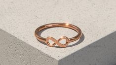 A beautiful Solid 9ct Rose Gold Infinity Ring. Special and powerful, the infinity symbol represents unending love, hope and eternity, making this necklace a fantastic anniversary, valentines, or mothers day gift idea, or even a little treat for yourself or a friend.  Synonymous with loyalty, many people believe the symbol represents limitless opportunity. Implying that something will last forever. This dainty ring shank is 1.5mm wide and the infinity symbol has a width of 10mm and a height of 4. Minimalist Rose Gold Infinity Ring, Symbolic Rose Gold Promise Jewelry, Minimalist Infinity Jewelry For Promise, Gold Infinity Promise Jewelry, Rose Gold Infinity Promise Jewelry, Rose Gold Infinity Jewelry For Promise, Dainty Infinity Rose Gold Rings, Symbolic Gold Infinity Jewelry, Symbolic Infinity-shaped Gold Jewelry