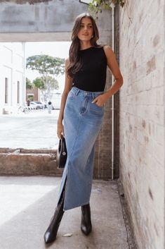 DETAILS   This midi length denim skirt is the perfect choice for a chic, feminine look. With a front zip fly and button close, you'll love how comfortable and secure it feels. Whether it's for work or play, you can be sure to look your best in this midi length denim skirt.    midi length denim skirt   front zip fly with button close  belt loops  functional front and back pockets  front split   unlined  m aterial - 100% cotton     SIZING    model is 5' 8" and wears a Size 2  model stats: bust -  30.5", waist - 24", hips - 36.5"        GARMENT CARE    cold hand wash separately Worship Outfits, Elegantes Business Outfit, Mode Chanel, Denim Skirt Outfits, Mode Boho, Skirt Denim, California Casual, Vintage Mode, Summer Fits