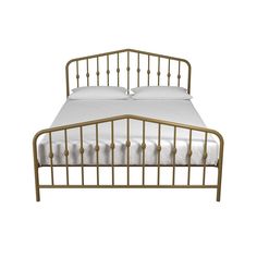 a metal bed frame with white sheets and pillows