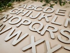 the letters are cut out of wood and placed on top of each other