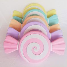 colorful candy lollipops are stacked on top of each other in the shape of a spiral