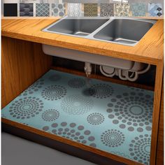 a kitchen sink under a counter with a blue rug