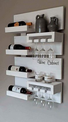 a wine rack with bottles and glasses on it