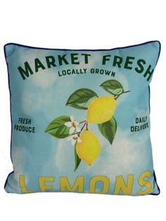 a blue pillow with lemons on it and the words market fresh locally grown