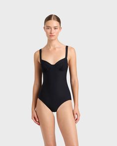 A modern classic, the Loures balconette one piece in black is cut from our luxury, Italian Sculpteur® fabric with patented 3-D stretch technology that flatters the silhouette. Loures features comfortable, wide, adjustable shoulder straps, an underwire for bust support and flattering gathers at mid bust. Ideal for those seeking tummy control, Loures is a classic swimsuit that will endure for years to come. Best suited to bust sizes B, C & D.Luxury fabric sustainably made in Italy. Elegant Swimwear With Built-in Bra And Underwire, Classic Black Lined Swimwear, Elegant Black Seamless Swimwear, Classic Fitted Lined Swimwear, Elegant Compressive Full Coverage Swimwear, Black Nylon Swimwear With Padded Cups, Elegant Stretch Swimwear With Removable Bra Pads, Elegant Compressive Solid Swimwear, Elegant Compressive Solid Color Swimwear