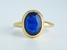 Lovely antique large blue sapphire ring in 10K yellow gold by the Plainville Stock Company of Victorian era Massachusetts. This pretty ring features a lovely oval sapphire set within a classic Victorian bezel mount. The stone appears to be original to the ring. The top of the ring measures 11.8mm north to south, and the sapphire measures 9x7mm. The entire ring is in excellent condition and bears the PSCO makers mark. Ring size 5 3/4 and easily sized up or down several sizes.  Please allow two we Classic Sapphire Ring Oval Cabochon, Classic Sapphire Cabochon Rings, Classic Oval Cabochon Sapphire Ring With Bezel Setting, Classic Sapphire Ring With Oval Cabochon Bezel Setting, Classic 14k Gold Sapphire Oval Cabochon Ring, Classic Yellow Gold Sapphire Ring With Cabochon, Classic Yellow Gold Sapphire Ring Oval Cabochon, Heirloom Oval Cabochon Sapphire Ring, Oval Sapphire Signet Ring In 14k Gold