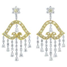 Impressive 27.90 carats of yellow diamond and white diamond chandelier earrings crafted in platinum and 18 karat yellow gold. The earrings have 13.89 carats of fancy yellow diamonds set in 18 karat yellow gold and 13.01 carats of white diamonds set in platinum. The earrings are designed with white diamond flower petals and a yellow diamond flower center. Connected with a single round brilliant diamond is a beautifully shaped bell crafted in 18 karat yellow gold with striking yellow diamonds. Sus Diamond Carat Size Chart, Carat Size Chart, Diamond Carat Size, Water Opal, Diamond Tops, Diamond Chandelier Earrings, Diamond Chandelier, Cognac Diamonds, Yellow Diamonds