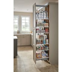 an open pantry door in a kitchen with lots of items on the shelves and drawers