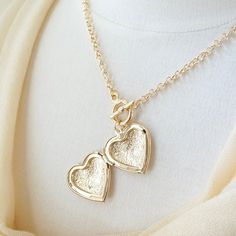 Heart Locket Toggle Necklace Details : - Heart locket for your photographs or secret messages - Thick round link chain, finished with a toggle clasp - Materials : 16K gold plated over brass - Necklace length : 18 inches - Heart Locket : 30 mm x 30 mm (~1.25 inches)- Locket inner dimension: 23 mm x 20 mm Heart Locket Necklace, Toggle Necklace, Necklace Chunky, Secret Messages, Brass Necklace, Heart Locket, Chunky Necklace, Toggle Clasp, Locket Necklace