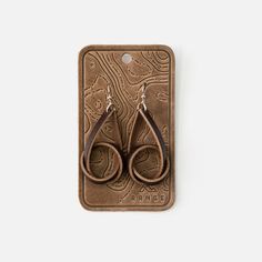 Our Knot Earrings are a unique and stylish twist on the traditional hoop earring. Made from high quality, full grain leather, they are rugged yet refined, making them the perfect addition to your accessory collection. American Flag Hat, Flag Hat, Wrist Wear, Dopp Kit, Knot Earrings, Minimalist Wallet, Custom Hats, Tote Backpack, Clutch Wallet