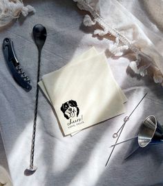 a pair of scissors sitting on top of a table next to some napkins and other items