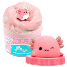 a pink squisk toy next to a plastic container