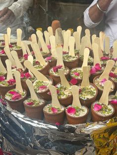 there are many cupcakes with wooden sticks sticking out of them