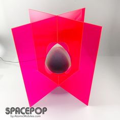 an unusual pink object with a hole in the middle