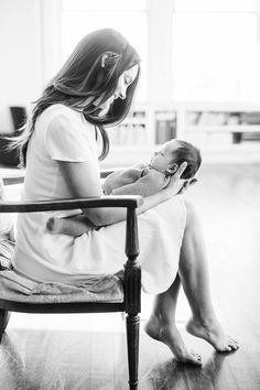 a woman sitting on a chair holding a baby in her lap with the caption interrest