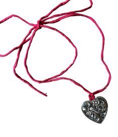 This beautiful heart-shaped pendant features a bow and flowers on both sides. Tied on hand-dyed red silk cord, it can be worn as a long pendant necklace or wrapped around the neck twice for a choker look. Tie the ends in an elegant draping bow for a more romantic look. Ribbon Choker Necklace, Ribbon Choker, Silk Cord, Romantic Look, Long Pendant Necklace, Long Pendant, Beautiful Heart, Red Silk, Silk Ribbon