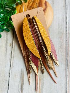 Mustard gold burnt red brown printed feather leather hoop earring/boho leather dangle earring/long leather earring/fall feather earring Lots of Fall layers! Sparkle mustard , fancy crackle gold ,gold, burnt pearlized red  ,fancy printed gold and pull up brown leather feathers,dangle earrings with gold plated hoops .Super light and ready to wear! Super statement earrings:) Hooks are lead and nickel free .Ready to sell will ship out same or next day in a gift box with tracking:) thanks for looking Boho Tassel Earrings, Brown Leather Earrings For Gift, Leather And Feather Earrings, Bohemian Leather Drop Earrings, Bohemian Leather Teardrop Earrings, Leather Feathers, Leather Feather Earrings, Brown Feather Dangle Earrings, Earring Long