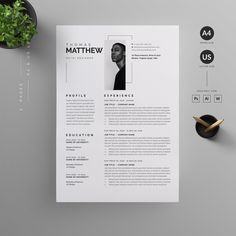 a clean and modern resume template on a table with a plant in the corner next to it