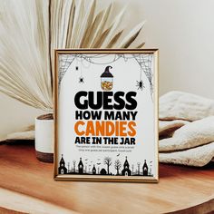 a sign that says guess how many candles are in the jar on a wooden table