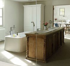 a bathtub and sink in a room with a mirror on the wall next to it