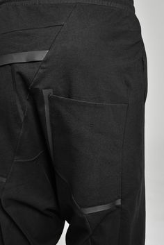 "DISTORTED BLACK DROPPED CROTCH TRACK PANTS WITH ELASTIC WAISTBAND __ELASTIC WAISTBAND WITH DRAWSTRING __J SHAPED LEGS __2 FRONT POCKETS __2 REAR BONDED POCKETS __ASYMMETRICAL HIDDEN FRONT CLOSURE model__ chest 103 (40.5\"), waist 77 (30.3\"), hips 96 (37.8\"), biceps 35 (13.8''), height 180 (5'11\"), kg 74 (163 lbs) wears size S color: black with black matte tape fabric__ 100 cotton care__ delicate machine wash at 30 c wash inside out use cool iron do not tumble dry sizing__ size XS (IT 44, US Black Straight Pants With Patch Pockets, Low Crotch Pants, Track Pants Mens, Cropped Linen Pants, Wool Pants, Black Linen, Black Matte, Cotton Pants, Pants Black