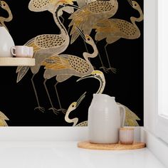 the wallpaper is black and gold with birds on it, as well as a vase