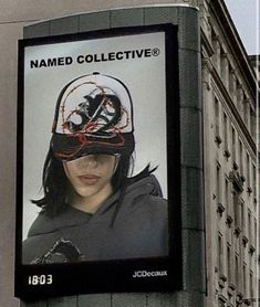 a billboard on the side of a building with a woman wearing a helmet and barbed wire