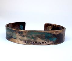 Our roman numeral bracelet is hand forged from rich jewelers bronze. Cuffs are hammered and hand stamped with the Roman Numeral date of your choice then aged in a natural solution to give it a verdigris patina. An anniversary, child's birthday or any special date you would like to commemorate. The aging process creates a different, organic patina on each piece. No two bracelets are exactly alike. A true one of a kind just like your love Each piece is sealed to protect it's finish. However, to pr Bronze Stamped Bracelet For Gift, Stamped Bronze Bracelets As Gifts, Stamped Bronze Bracelets For Gift, Gift Bronze Stamped Bracelets, Bronze Stamped Jewelry For Anniversary, Bronze Patina Bracelets As A Gift, 19th Anniversary Gifts, Roman Numerals Dates, Roman Numeral Bracelet