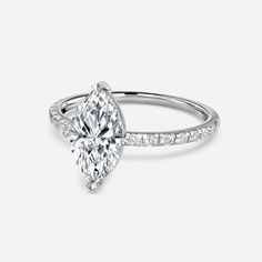 a pear shaped diamond engagement ring with side stones