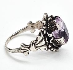 Astro Hungarian Arts and Crafts 2.66ct amethyst antique sterling silver ring. Good vintage condition with little signs of normal vintage wear. Great vintage patina. Unique wide handcrafted prongs hold a 2.66 ct amethyst. Stamped Hungary 800 on the top surface of the ring band. Acid tests positive for sterling silver. Gemstone tested with Presidium II gemstone tester. Ring measures size 8. Silver Victorian Amethyst Oval Ring, Silver Victorian Oval Amethyst Ring, Victorian Silver Amethyst Ring, Victorian Sterling Silver Hallmarked Amethyst Ring, Antique Collectible Amethyst Ring With Center Stone, Antique Silver Amethyst Sterling Silver Ring, Ornate Amethyst Silver Rings, Vintage Sterling Silver Purple Rings, Vintage Amethyst Sterling Silver Ring