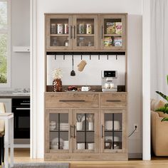 a wooden cabinet with glass doors in a living room next to a table and chairs