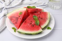 slices of watermelon on a plate with mint