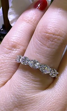 a woman's hand with a diamond ring on it