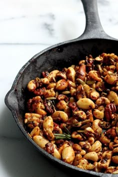 a skillet filled with nuts on top of a table